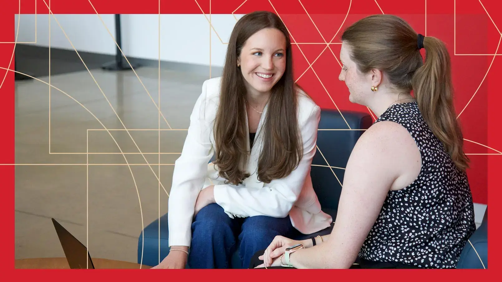 Burlington Location Planning Analyst Tess Coyne discusses her latest analysis with a coworker. The photo has a red border and thin, gold, and geometric lines running through the background.