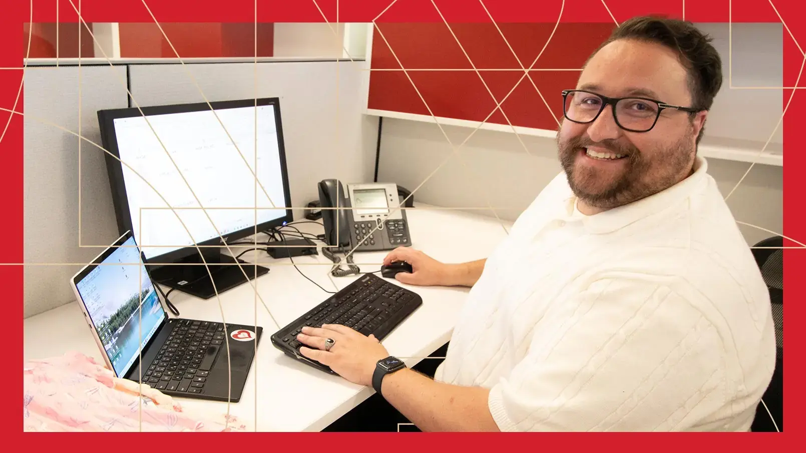 Burlington Assistant Buyer Zach Forgani sits at desk, ready to work. The photo has a red border and thin, gold, and geometric lines running through the background.